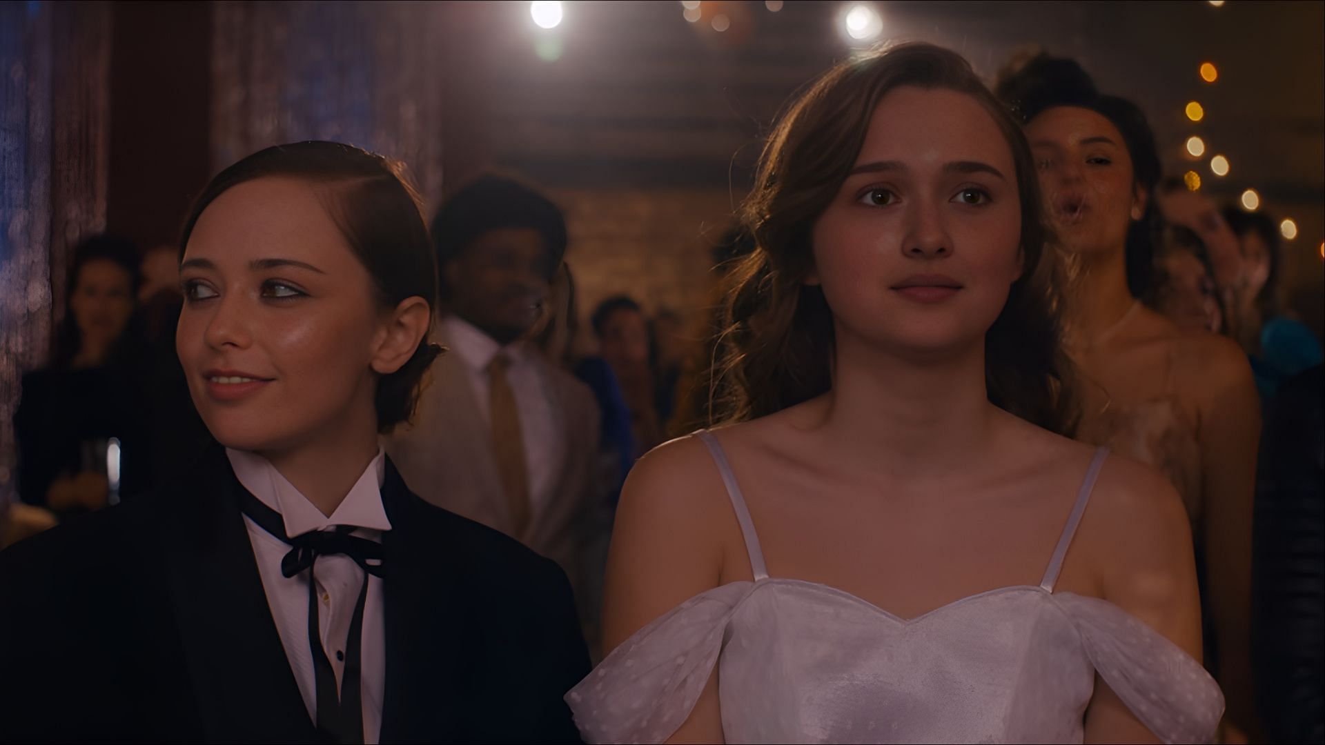 Lori Granger (India Fowler) stands alongside Megan (Suzanna Son) as the prom festivities begin in Fear Street: Prom Queen (Image via Netflix)